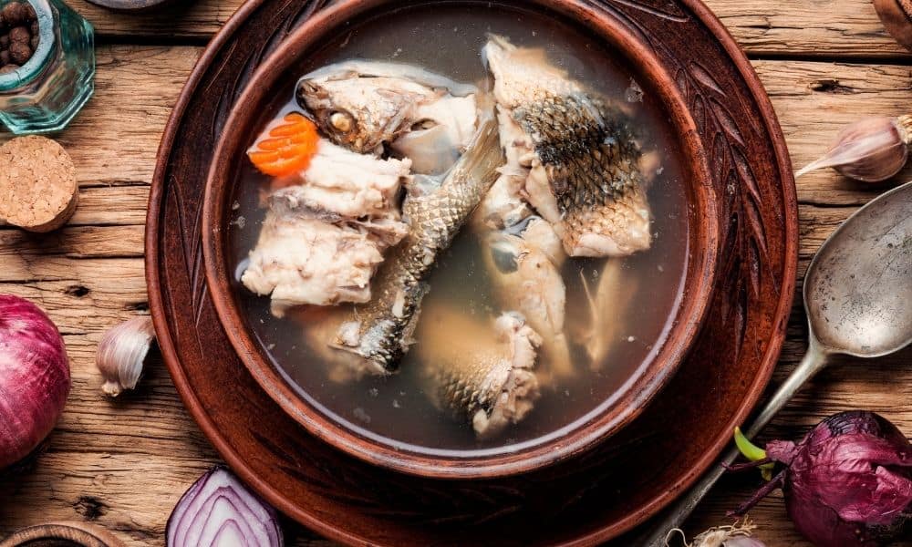 Fish stock in a brown bowl.