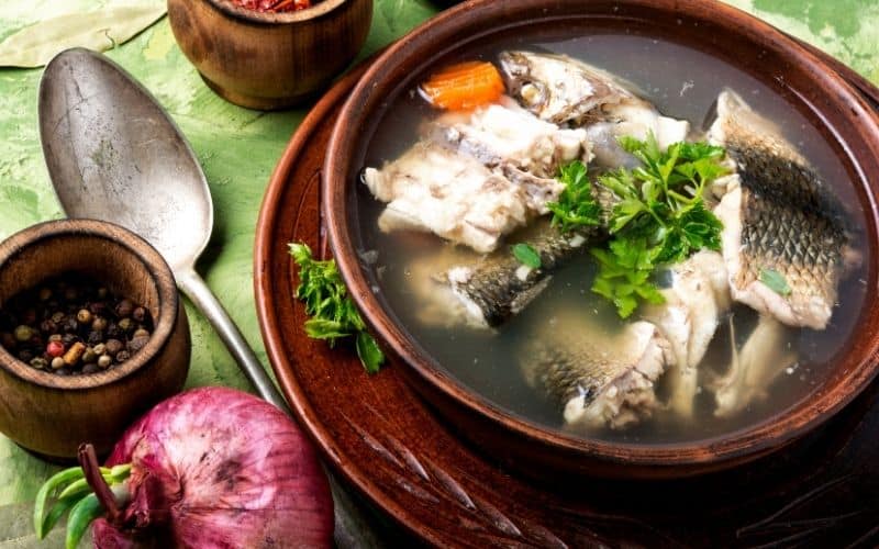 Fish stock in a brown bowl.