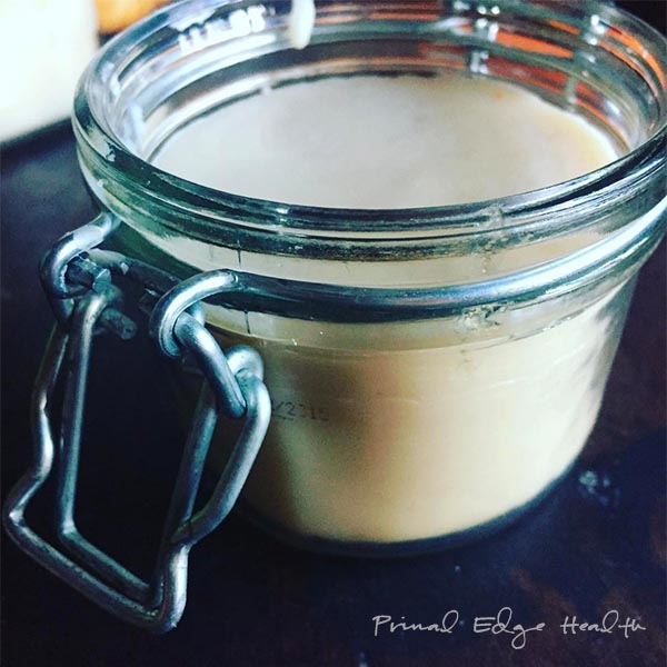 Beef tallow in a glass jar.
