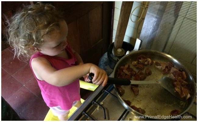 A child helping cooking something healthy.