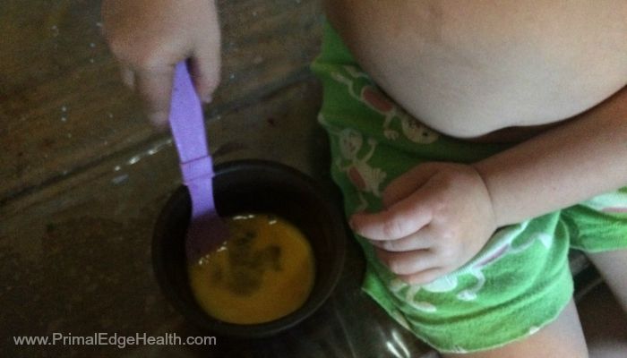 A child getting a scoop of healthy snacks.