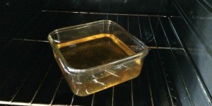 Yellow liquid in a baking dish inside the oven.