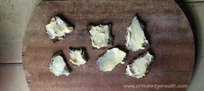 Pieces of healthy snacks with white cream on top.