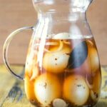 A pitcher of pickled eggs.