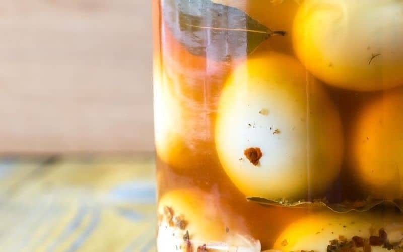 Low-carb pickled eggs in a glass container.