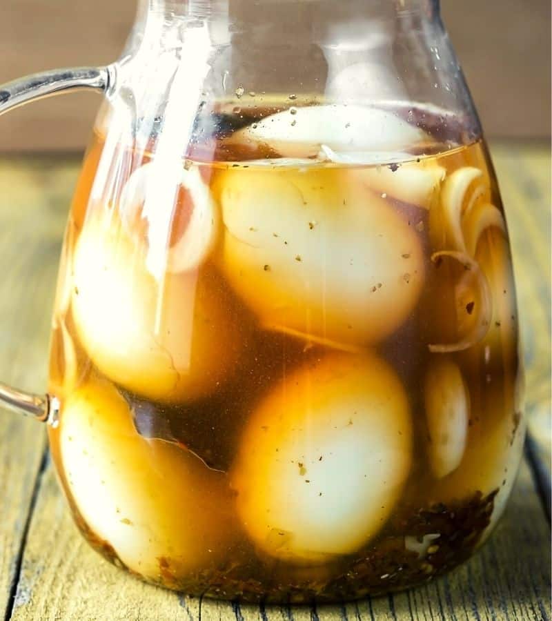 Pickled eggs in a pitcher.