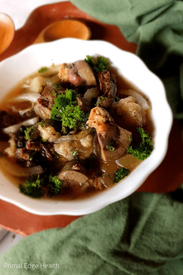 Organ meat stew in a white bowl.