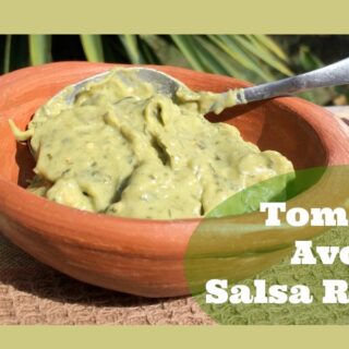 A serving of tomatillo avocado salsa in a brown bowl.