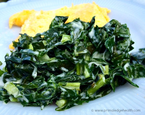 Creamed greens with egg omelette on a white plate.