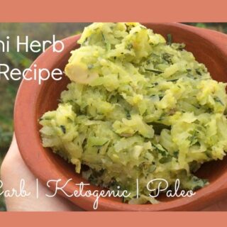 A serving of low-carb zucchini herb butter in a brown bowl.
