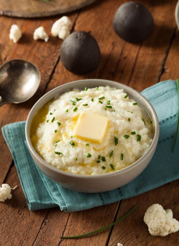 Keto mashed potatoes in a cream colored bowl.