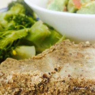 A slice of pemmican with vegetables in the background.