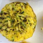 Garlic zucchini scrambled egg muffins on a white plate.