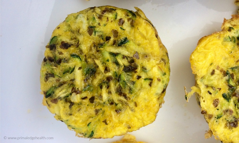 Garlic zucchini scrambled egg muffins on a white plate.