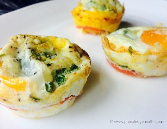 Three tomato zucchini eggs on a white plate.