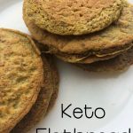 A stack of round, golden-brown keto flatbread sits on a white plate, with the words "Keto Flatbread" displayed.