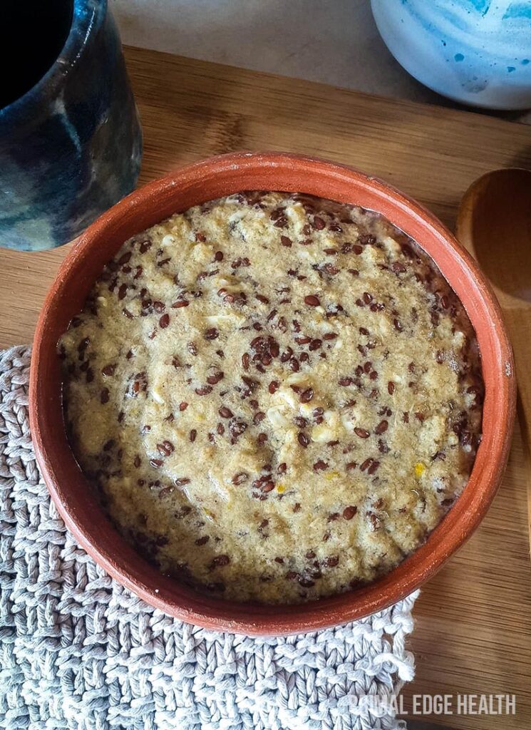 A bowl of hot keto cereal on a wooden surface.