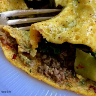 Low-carb stir fry omelette in a white plate.