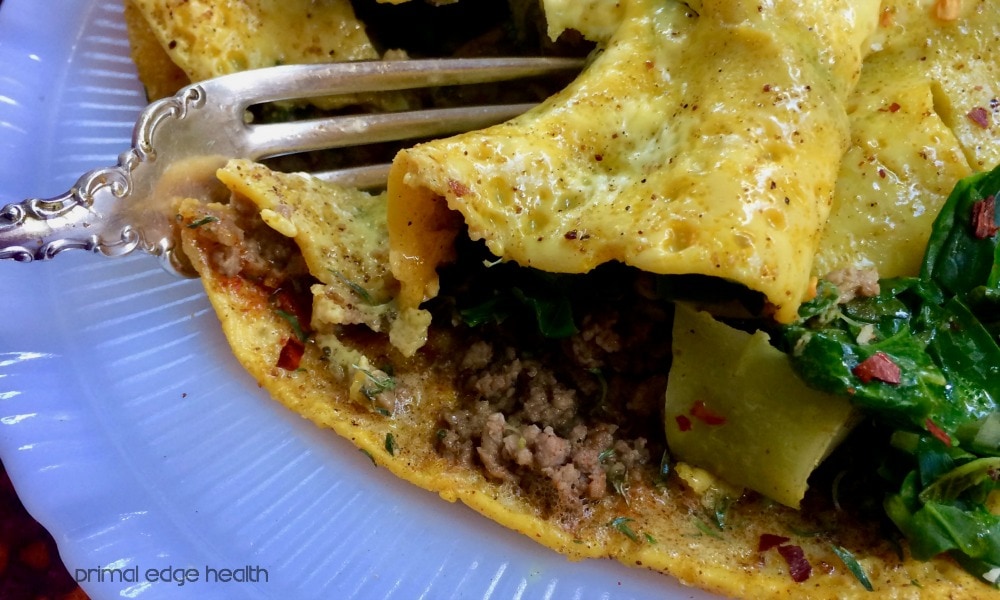 Low-carb stir fry omelette in a white plate.