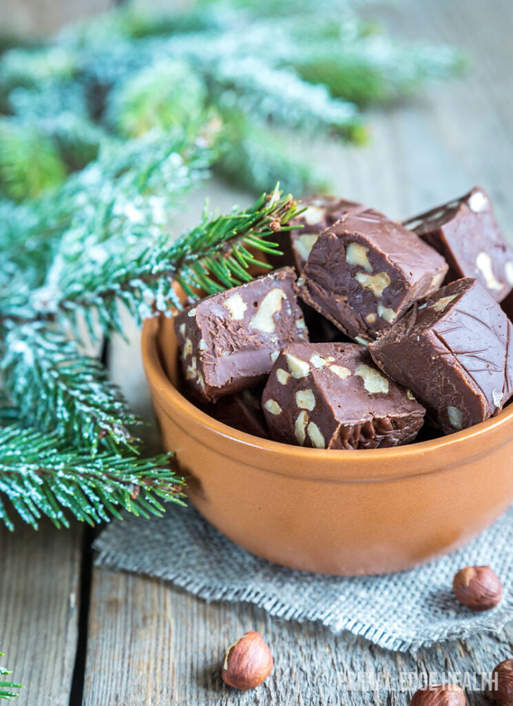 Keto nutella fat bombs in a brown bowl on a wooden surface.