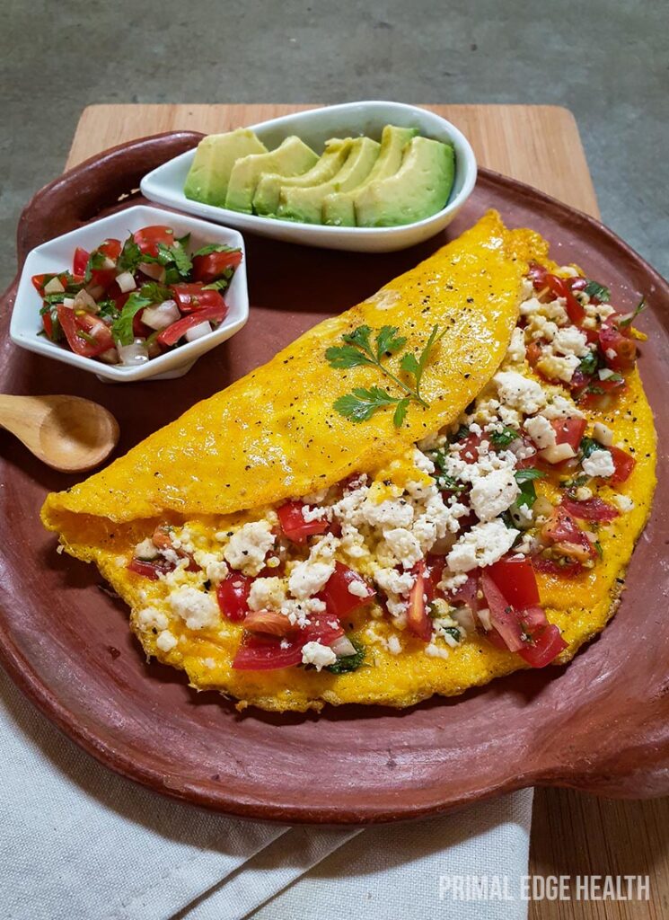 A serving of Mexican omelette with garnish on a brown plate.