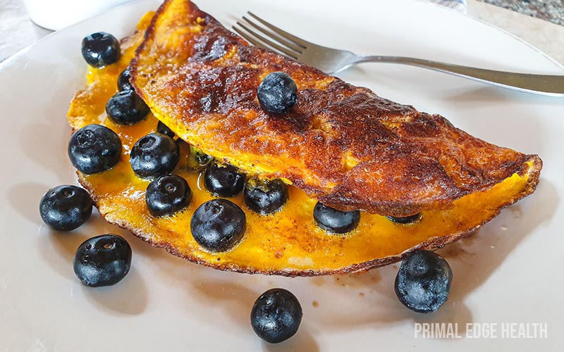 Golden brown Sweet omelette served with blueberries.