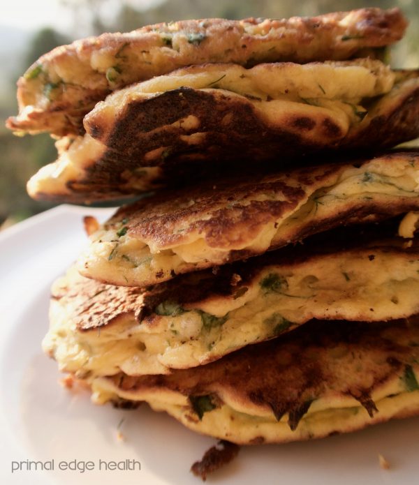 A stack of fennel and feta pancake on a plate.