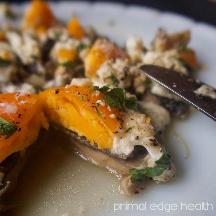 Portobello egg bake on a plate with a knife.