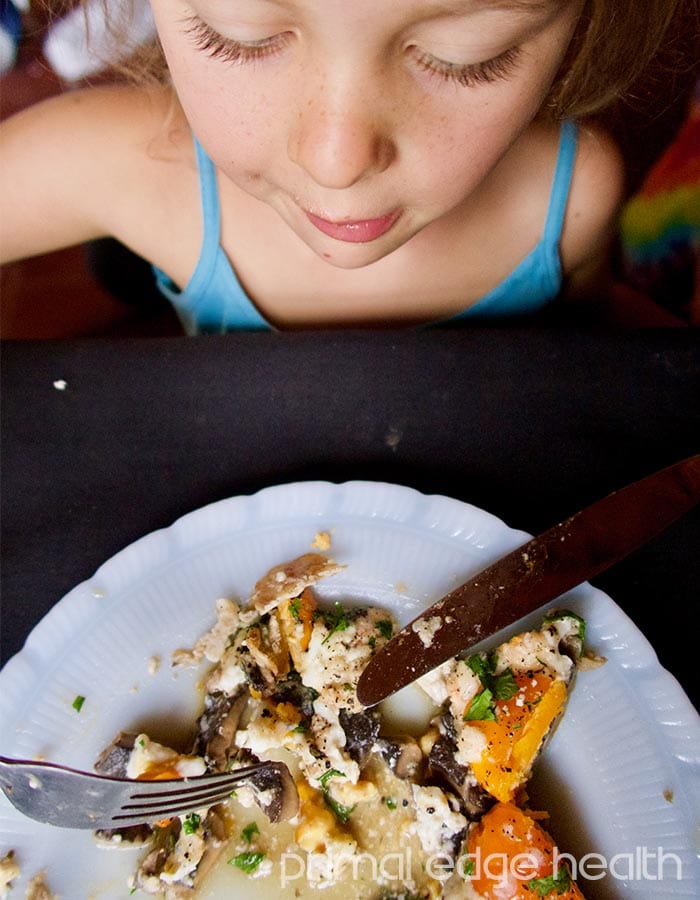 A child who's about to eat portobello egg bake.