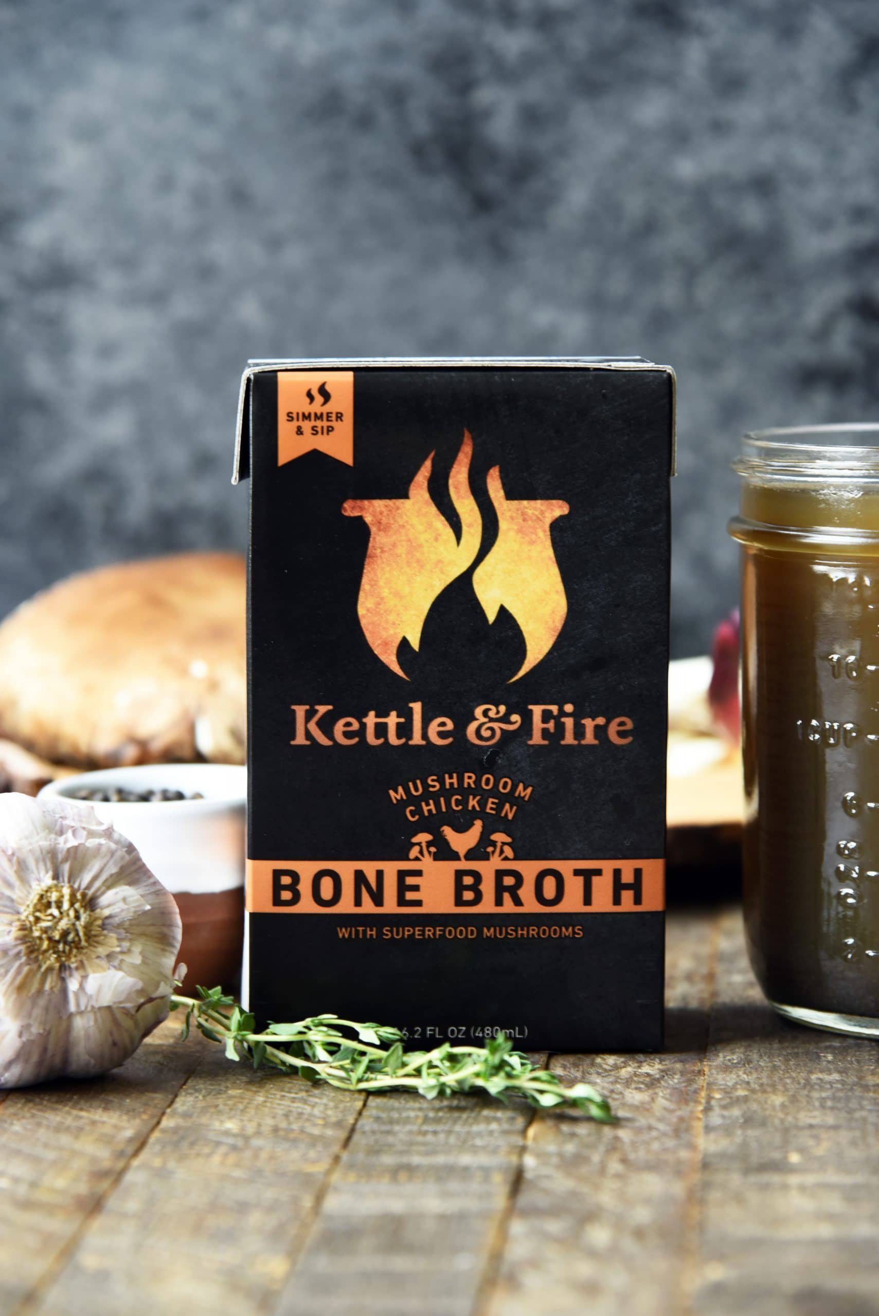 Kettle and fire ketogenic chicken soup carton next to different kinds of ingredients.