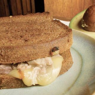 A serving of avocado tuna melt on a plate.
