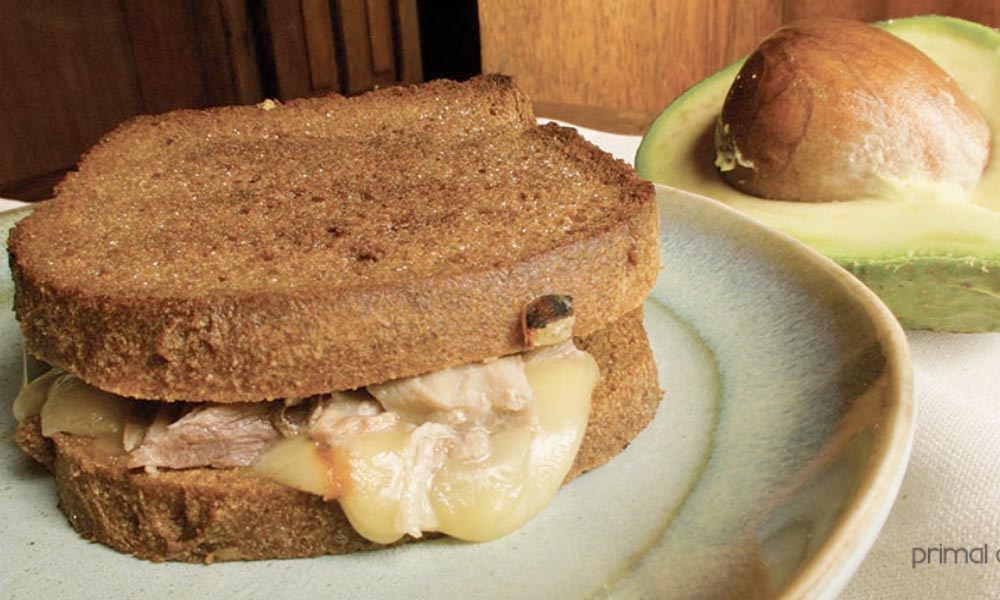 A serving of avocado tuna melt on a plate.