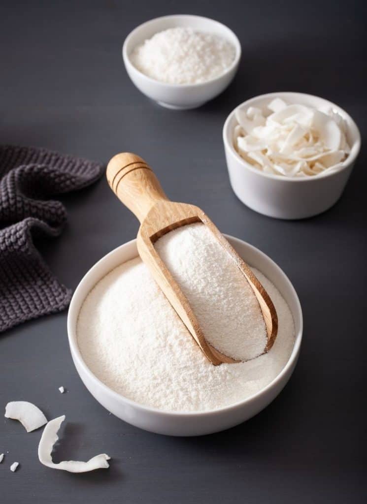 Flour in a white bowl on a grey surface.