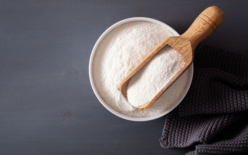 Coconut flour in a white bowl.