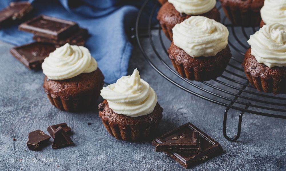 Frosted cupcakes on a cooling rack.