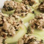 A batch of tuna cucumber bites on a white surface.