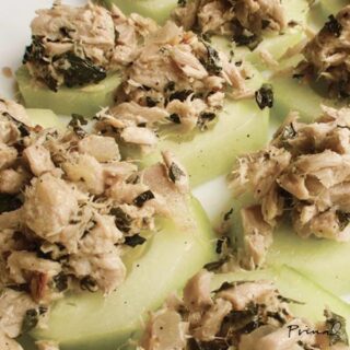 A batch of tuna cucumber bites on a white surface.
