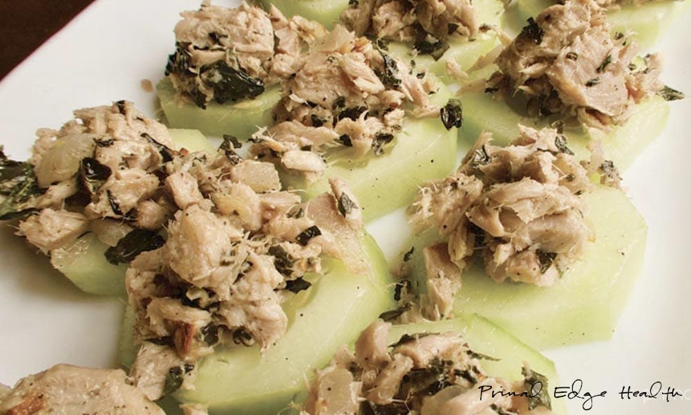 A batch of tuna cucumber bites on a white surface.