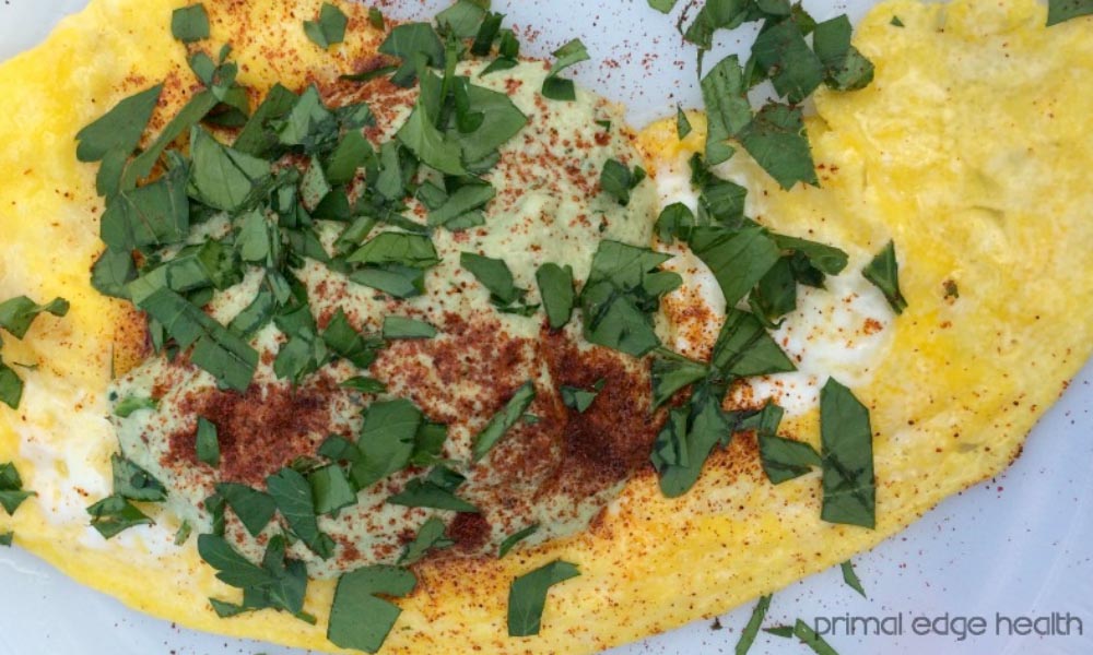Omelette with garnish on a white surface.