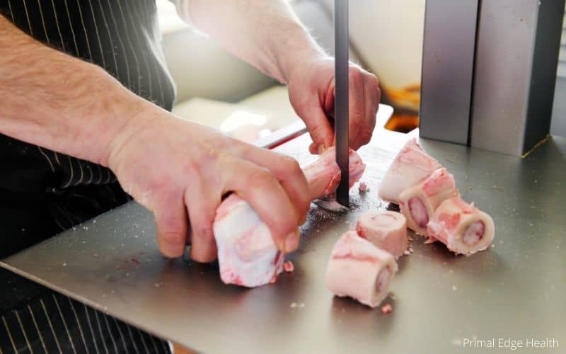 Animal bone being cut into pieces.