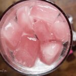 Pique tea hibiscus spritzerin a clear glass.