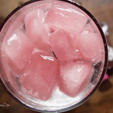 Pique tea hibiscus spritzerin a clear glass.