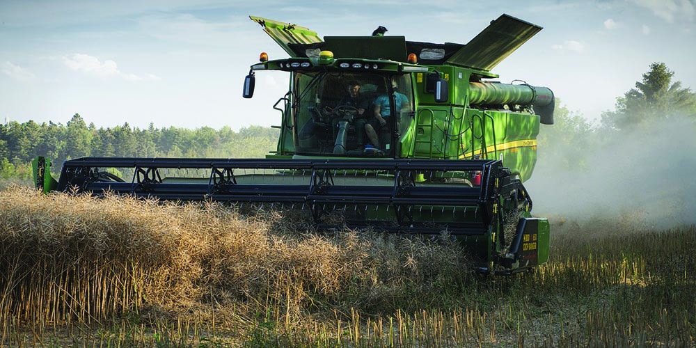 A harvesting truck harvesting some grains.