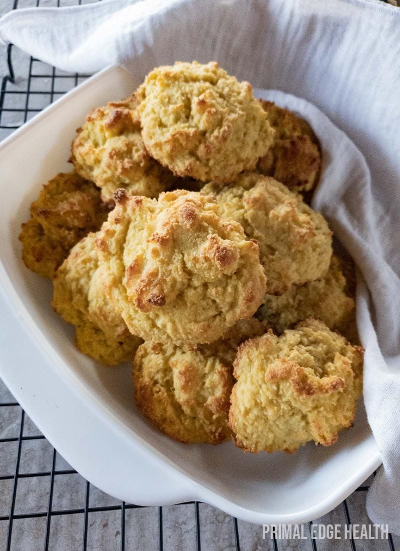 A white dish of keto drop biscuits on a wire cooling rack.