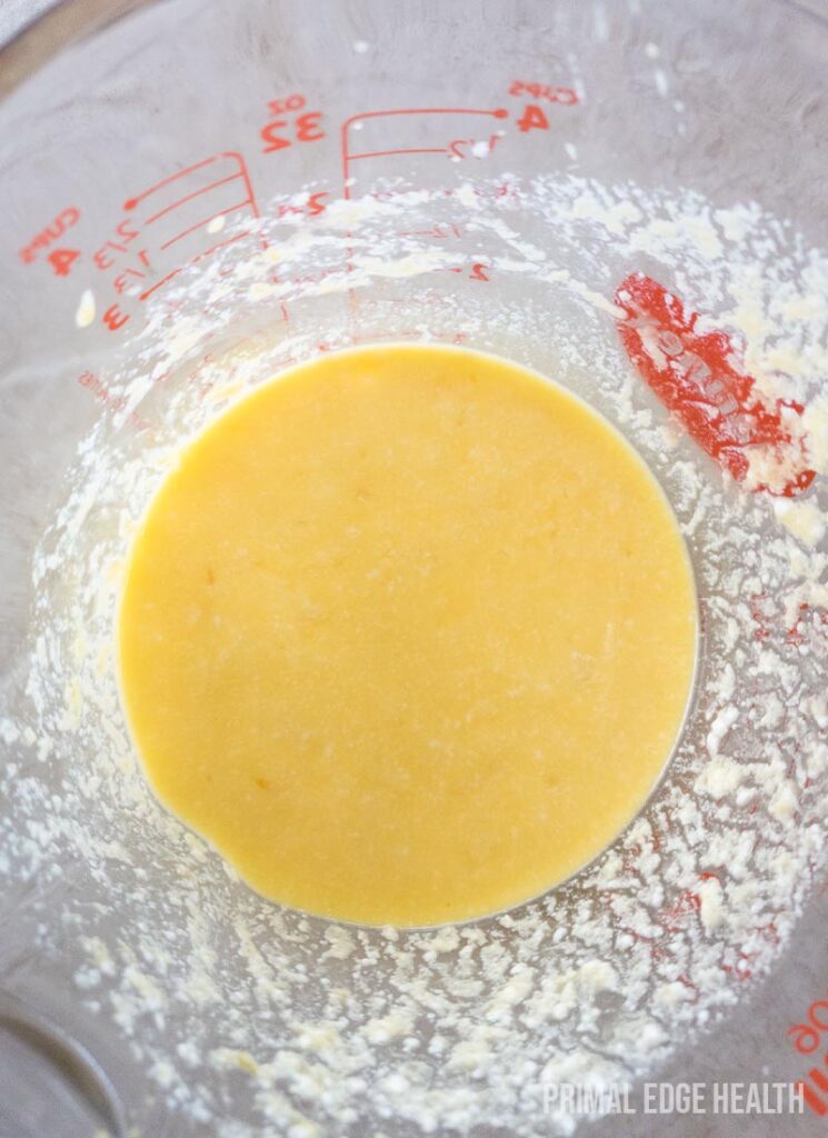 A yellow liquid mixture in a measuring cup.