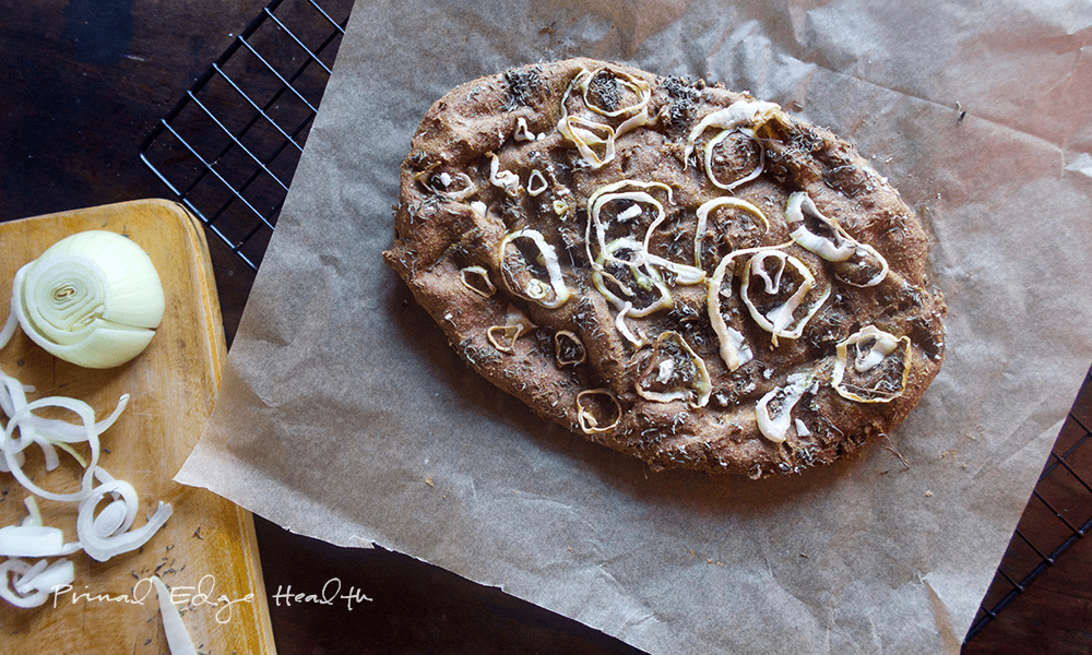 Low-carb focaccia bread on a parchment paper.