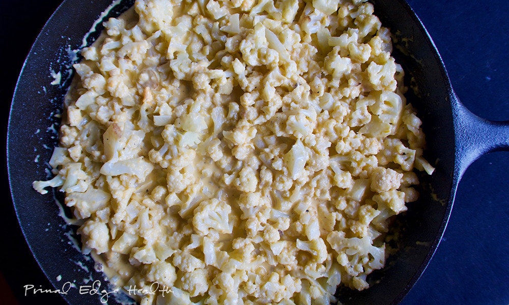 A keto cauliflower mac and cheese served in a cast iron skillet.