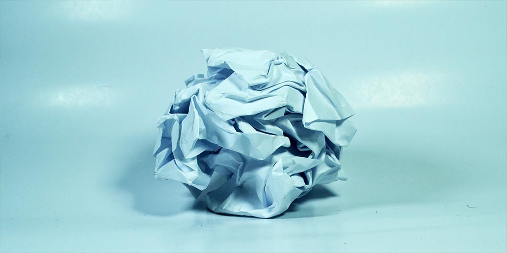 Crumpled blue paper with light blue background.