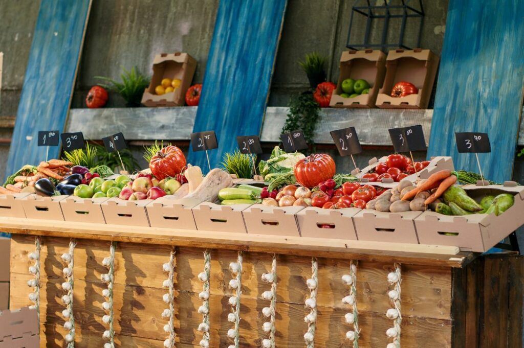 A display of quality fruits and vegetables on a wooden table at farmers' market.