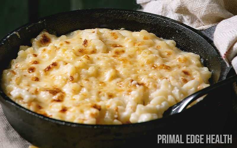Baked cauliflower mac and cheese served in a black pan.